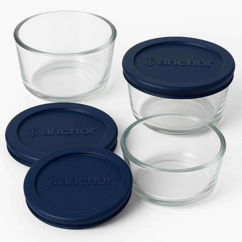 Four round Anchor Hocking glass containers with navy lids demonstrating stackable nesting