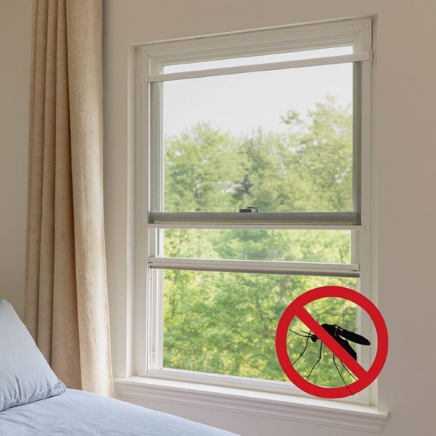 Adjustable aluminum window screen expanded to fit a double-hung window, letting in fresh air while blocking insects