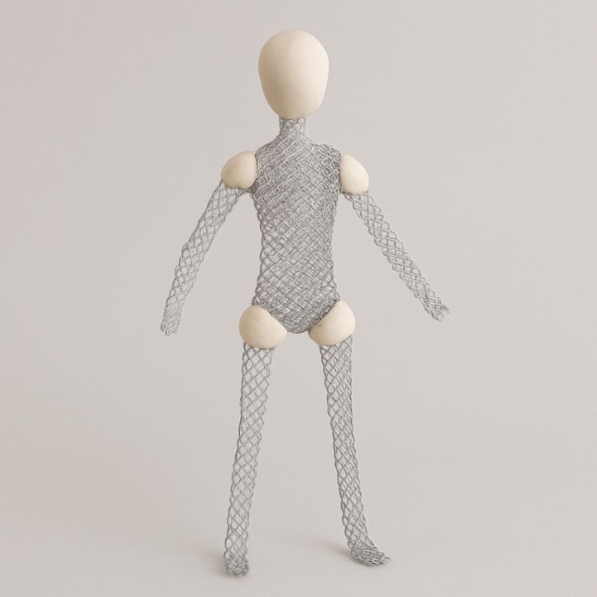 In-progress sculpture armature made from aluminum mesh with clay built over joints