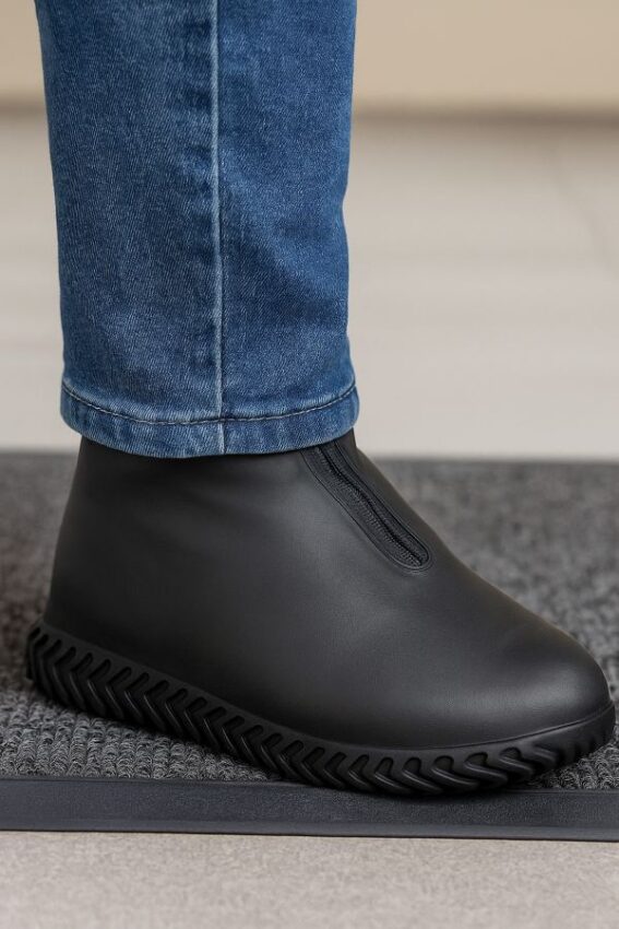 Pants cuff covering the top of a shoe cover to limit rain entering from above.