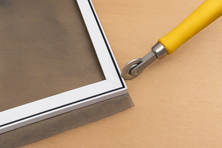 Rolling spline into the screen groove while mesh overlaps the frame edges.