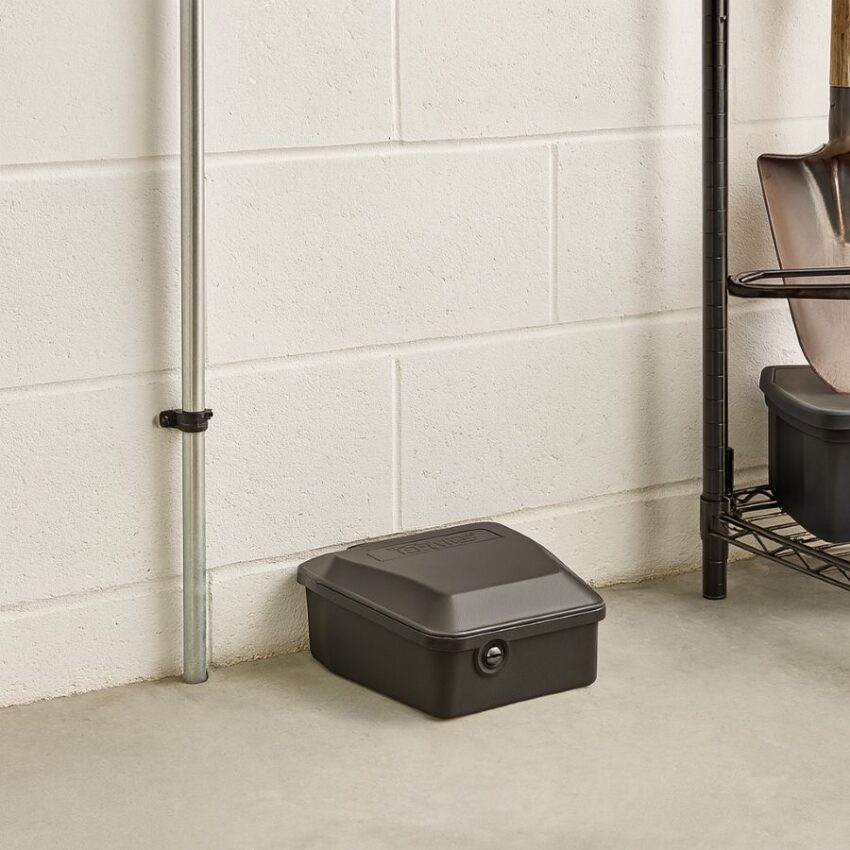 Tomcat Rodent Station placed flush to a garage wall for discreet, lockable rodent control