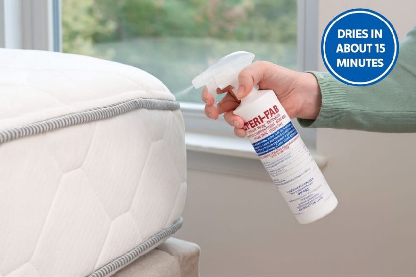 Applying Steri-Fab along a mattress seam with the window open, quick-drying contact kill for bed bugs on fabrics